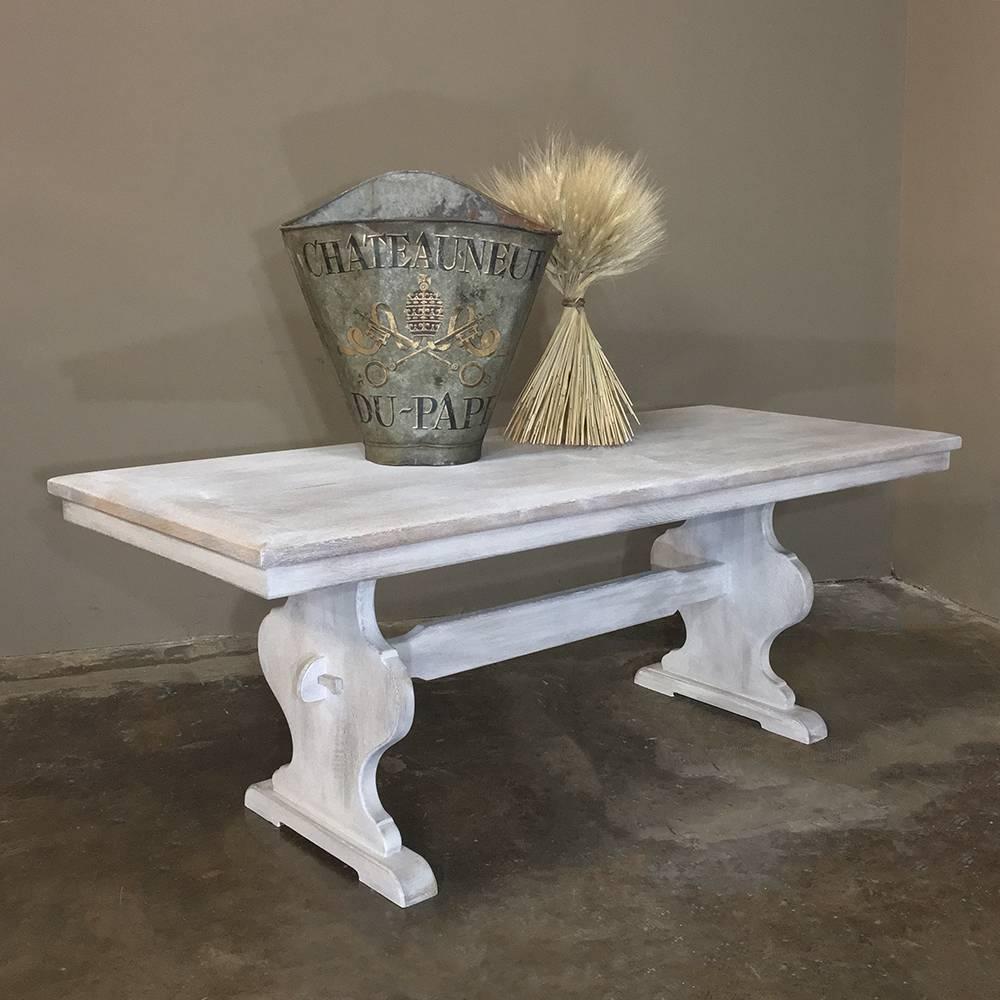 Antique rustic whitewashed painted trestle table is perfect for today's casual decors, and provides an incredibly strong and stable platform evolved from centuries of the cabinetmaker's art! The urn-shaped side supports are secured to the thick,