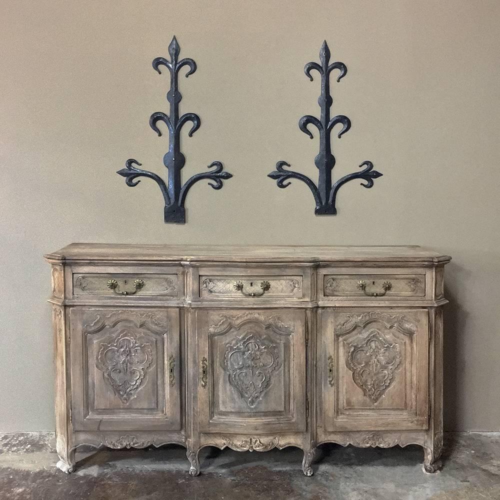 Pair 18th Century Wrought Iron Fleur de Lys Wall Decorations were originally adorning grand chateaux, but have been repurposed to serve as interesting architectural decorative items for your pure enjoyment! Hand-forged from solid iron, each features