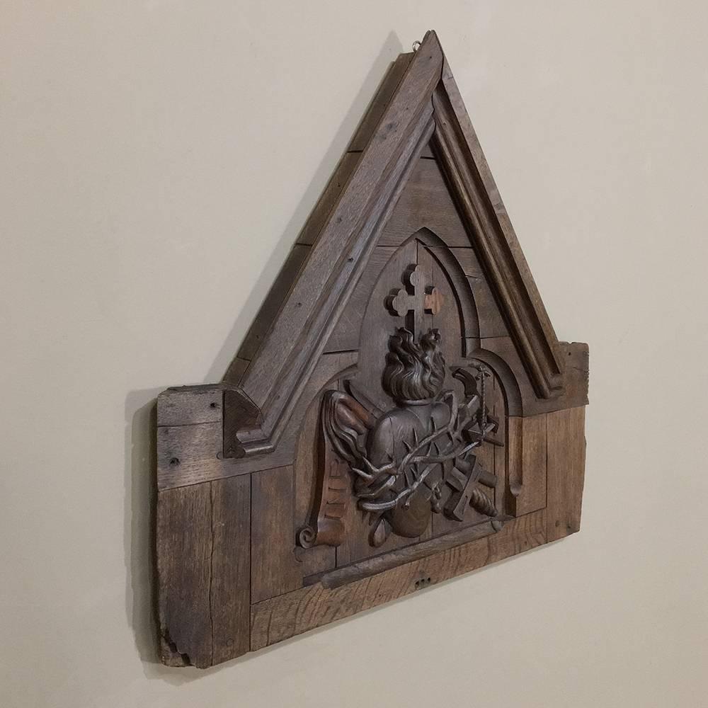 19th century Gothic hand-carved oak religious wall decoration was discovered in a private chapel and features the Sacred Heart with symbolism surrounding the crucifixion. An exquisite example of the devotion of an obviously talented