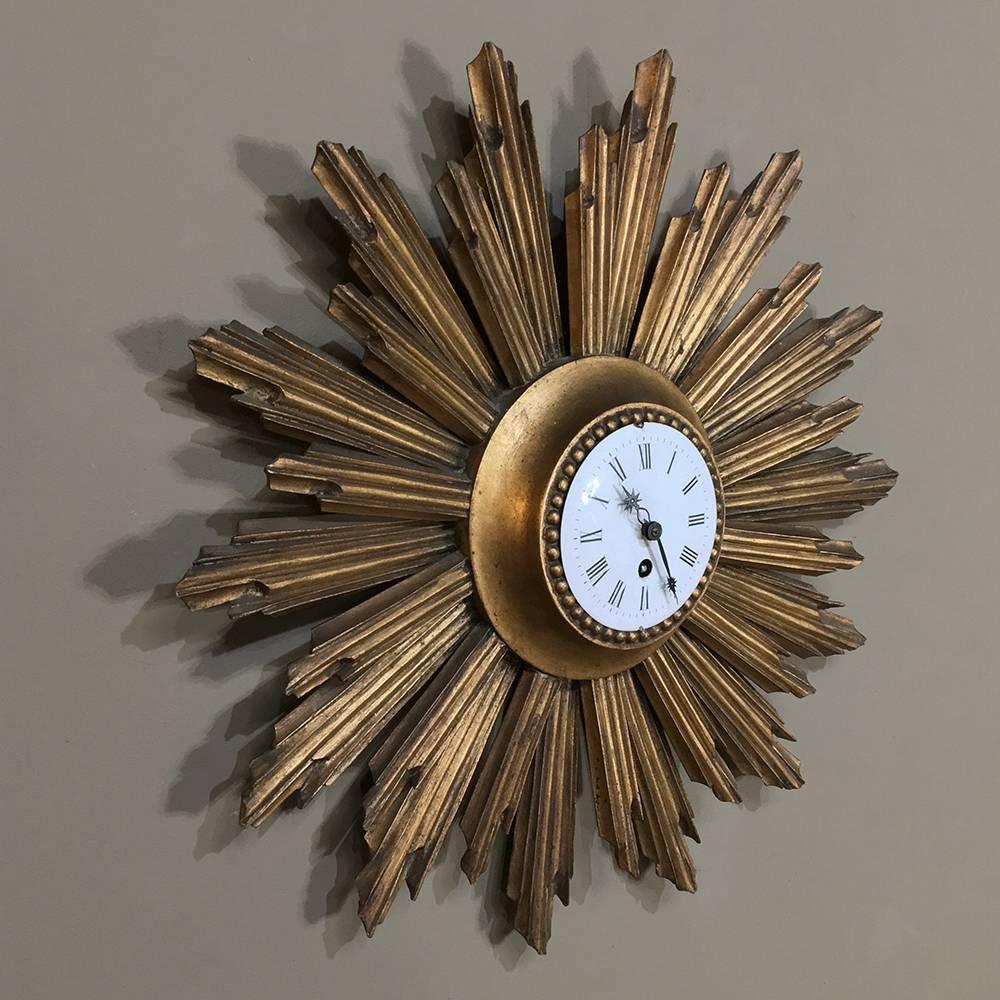 Mid-Century carved wood French giltwood sunburst wall clock was handcrafted from solid wood then given a beautiful porcelain dial with Roman numerals and starburst hands. Perfect for adding a special touch to your decor in any room,

circa early