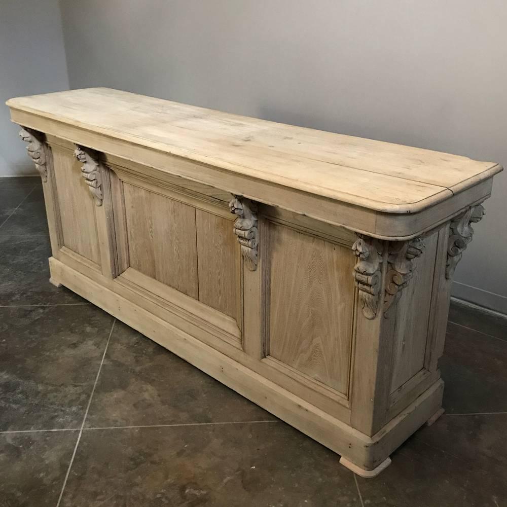 Antique 19th century French oak store counter is the ideal choice for an antique bar or even a kitchen island! handcrafted and carved to a high degree of artistry from olld-growth quarter-sawn oak, it was designed to last for centuries. Perfect for