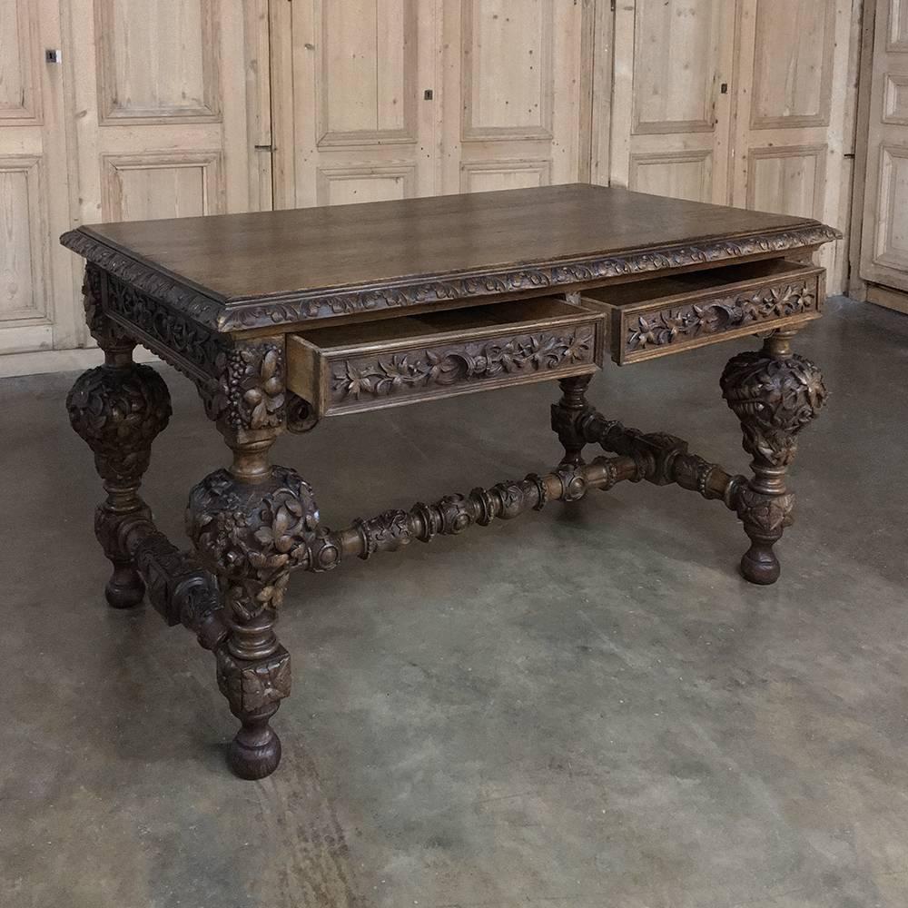 This 19th century French Renaissance oak desk is simply a masterwork of the sculptor's art! the intricacies of the full relief carving that abounds across the entire facade, down the massive inverted urn legs and across each of the stretchers is a