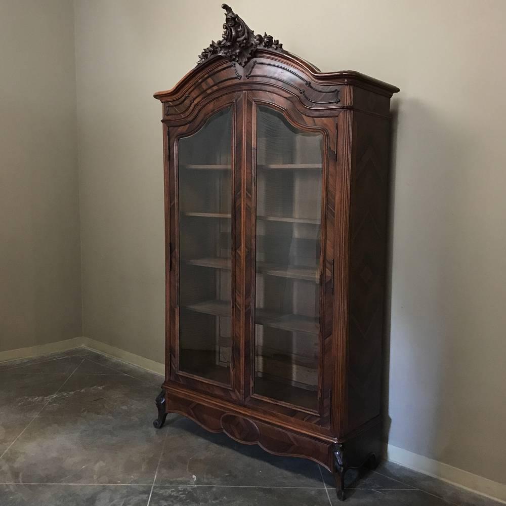19th Century French Louis XV rosewood bookcase is an example of a once-relatively common item becoming very rare to find! Rosewoods were imported from the Americas to Europe to the finest furniture making houses for a very limited time period during
