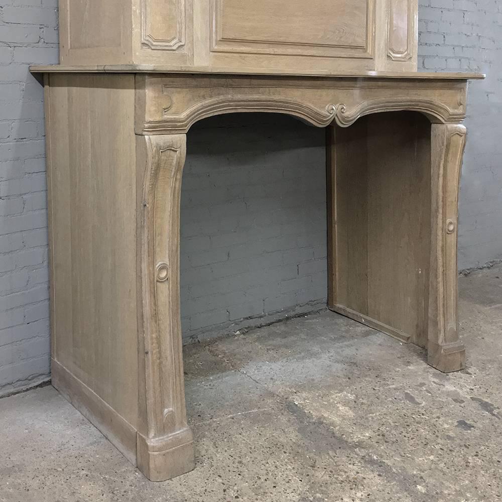 18th century hand-carved oak fireplace surround represents the essence of understated elegance, with just a touch of Baroque-inspired adornment in the scrolled framework around the chamfered panels, and the double scrolled fireplace opening. The