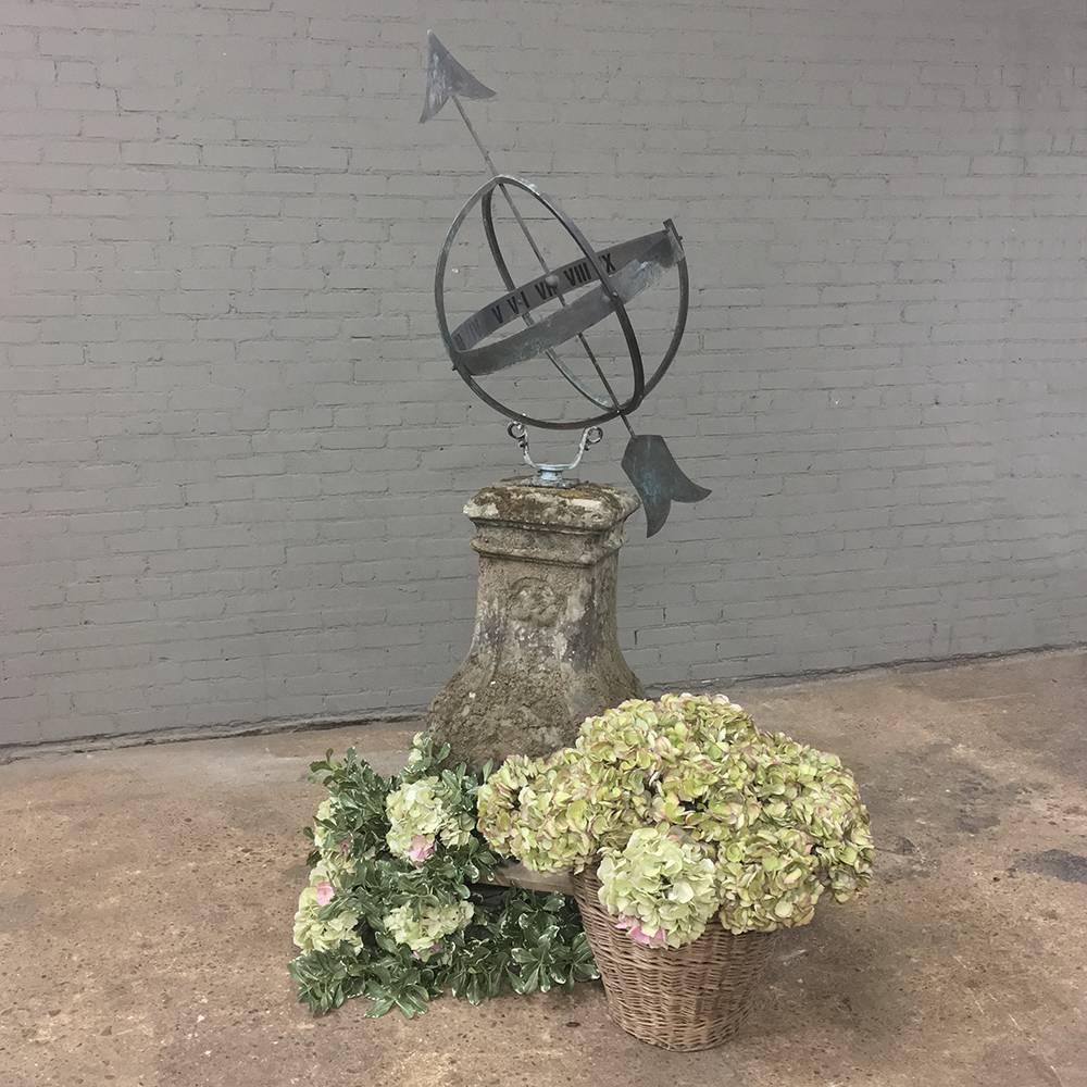 Cast stone and iron armillary is ideal for the garden, having served as both adornment and as a timekeeping device for well over a century!  The cast stone is showing true patina on age-appropriate surface with remnants of moss and a trace of