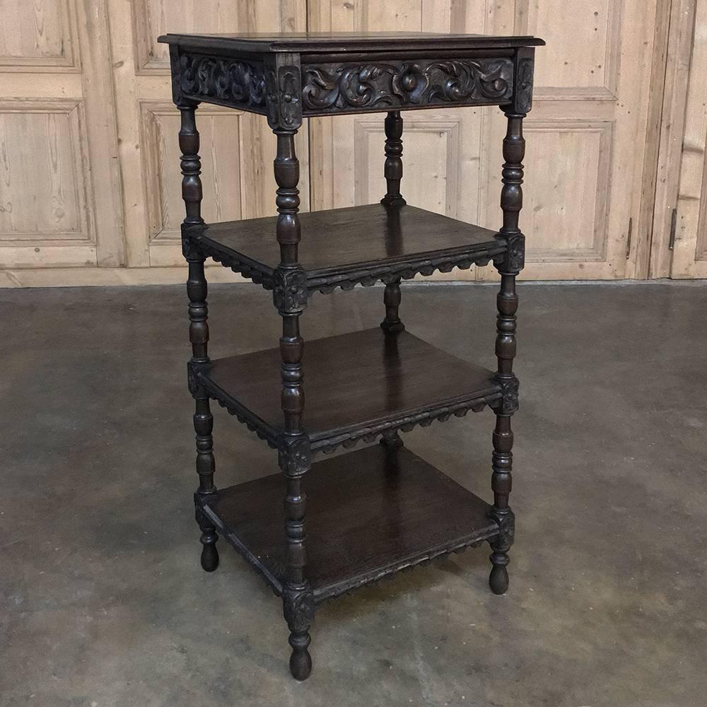 19th century French Renaissance étagère stand is ideal for the office, between a pair of windows, or even in a seating group, providing multiple shelves for display. Carved detail on the top apron includes a full-width drawer facade is supported by