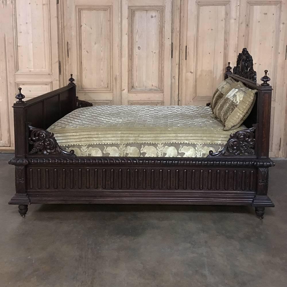 This stunning 19th Century Renaissance French hand-carved Bed was sculpted from dense, old-growth quarter-sawn oak to last for centuries, and features elaborate hand-carved detail all around, making it an excellent candidate as the primary bed in