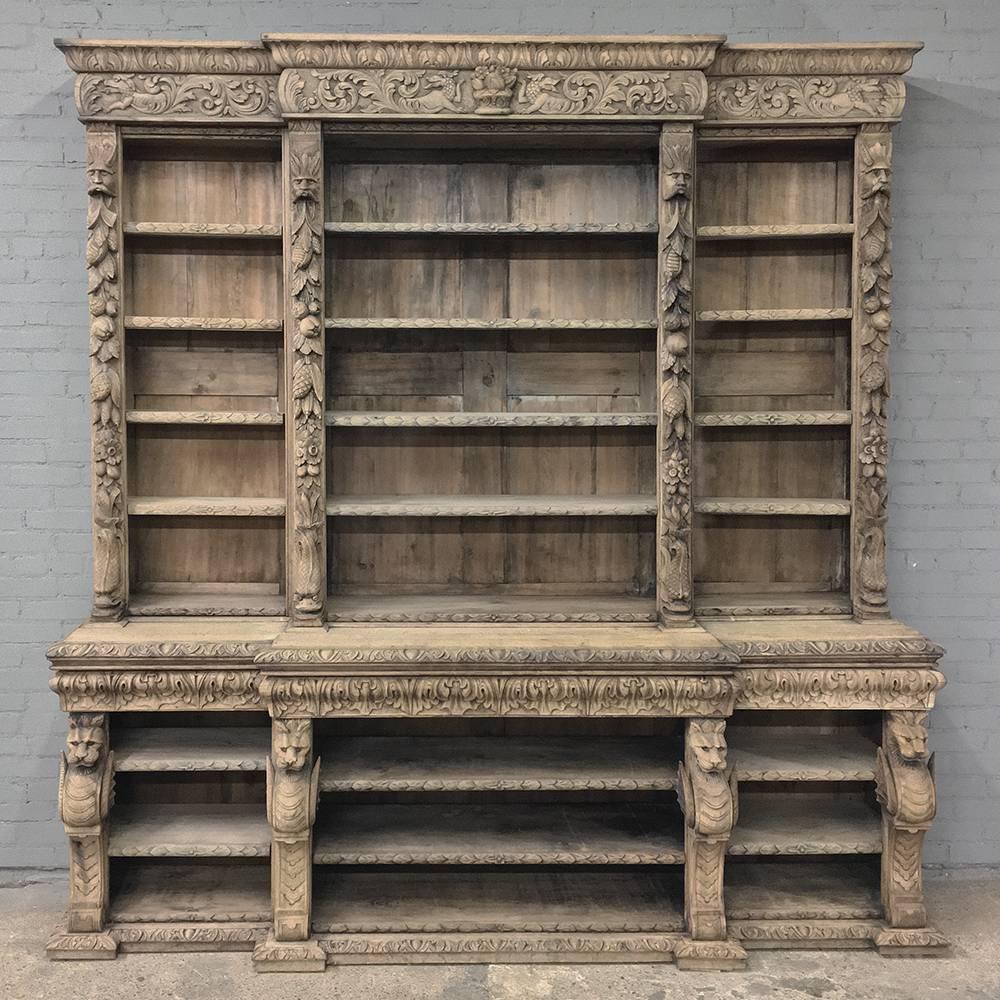 19th century stripped oak English Renaissance open bookcase is a grand way to display your books and collections in style! Boldly carved in the Renaissance manner from the step-front massive crown above, down the cornerposts to the step-out lower