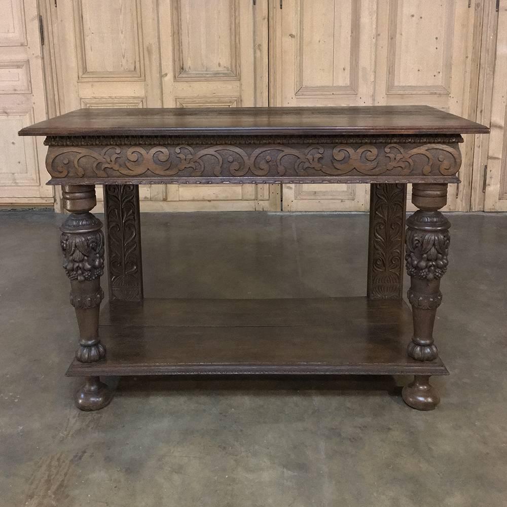19th century French Renaissance console, sofa table features hand-carved sculpture that would catch the eye even of Louis XIV himself, who ushered in the Baroque style to the French Court. Della Robia design dominates the large column supports, with