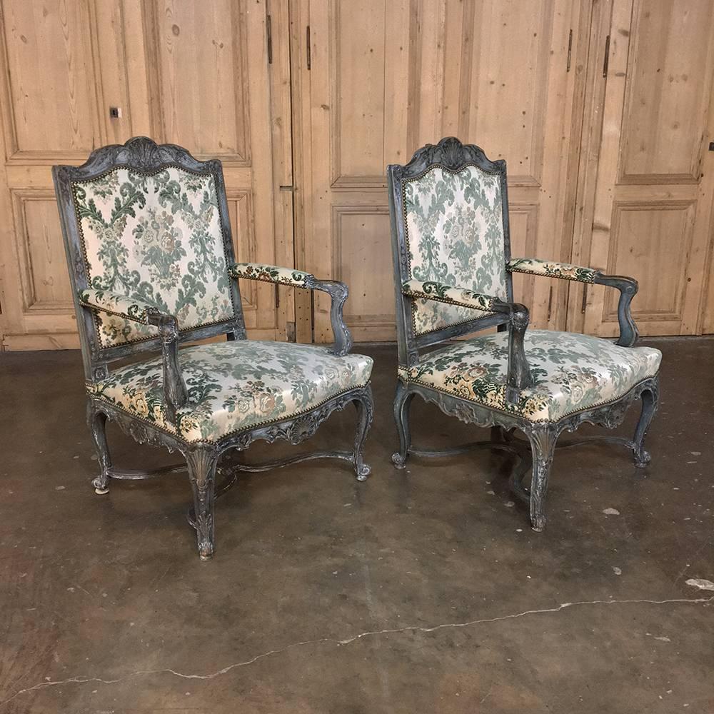 Pair of 19th Century French Louis XIV Painted Armchairs are a feast for the eyes! Gracefully contoured and sculpted frames were hand-carved from solid walnut then given a patinaed painted finish which accentuates the fine hand-carved detailing that
