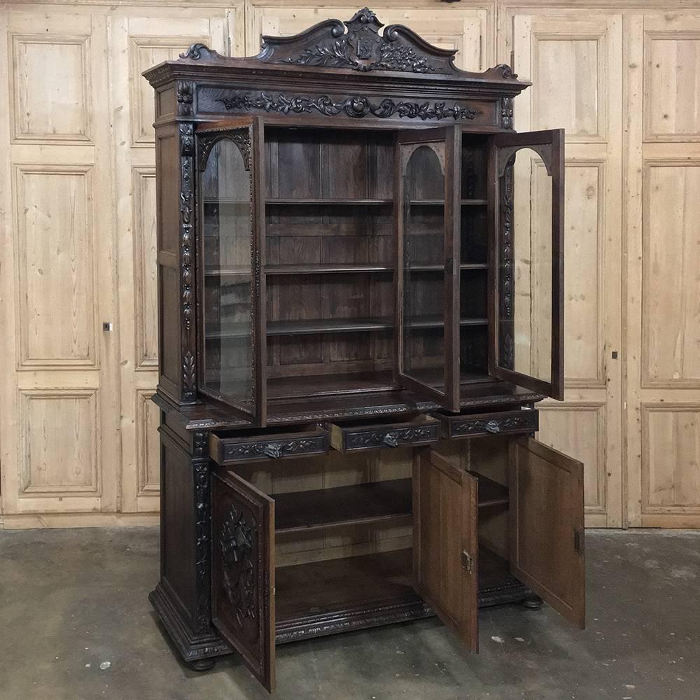 This stunning 19th century French Renaissance triple bookcase is the perfect way to display your finest library, collection, trophies, or even have us convert it into a spectacular gun cabinet! Use your imagination! Hand-carved from solid oak to