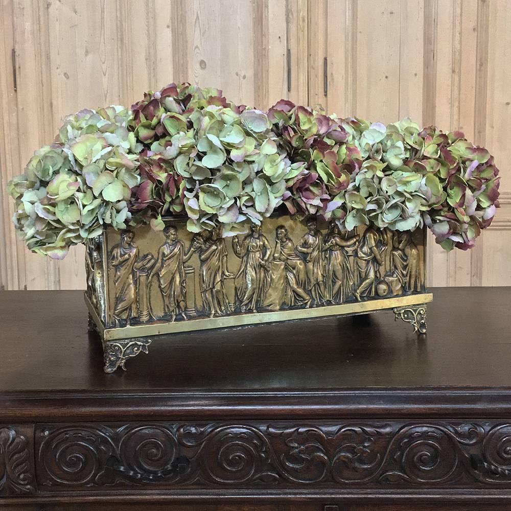 19th century French embossed brass jardinière. Planter is embossed on all four sides making it a great choice as a centerpiece for the table! Original tin liner was designed to keep your surfaces protected from excess water. Jardinieres were