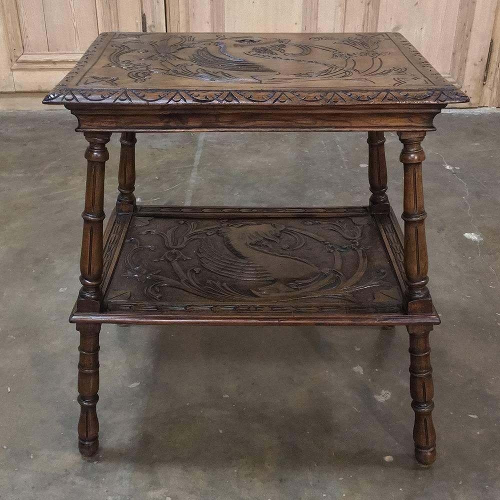 Carved on every visible surface, this handsome 19th century Italian Renaissance walnut end table features mythical creatures, finely carved edging, and turned legs for a stunning example of Old World craftsmanship that has no equal in today's
