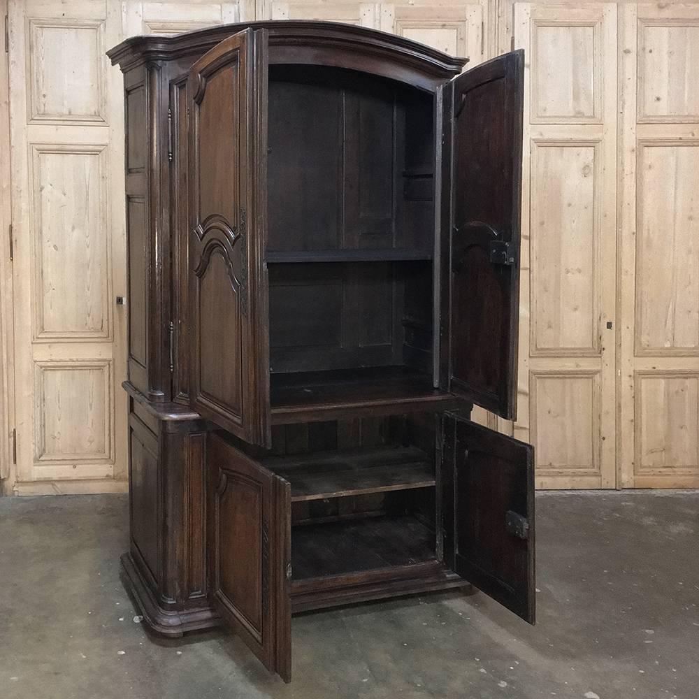 18th century monumental country French buffet a deux corps was handcrafted from solid old-growth quarter-sawn oak, and possesses a very unusual feature on the top tier. The upper doors are mounted on a double-jointed hinged system that allows the