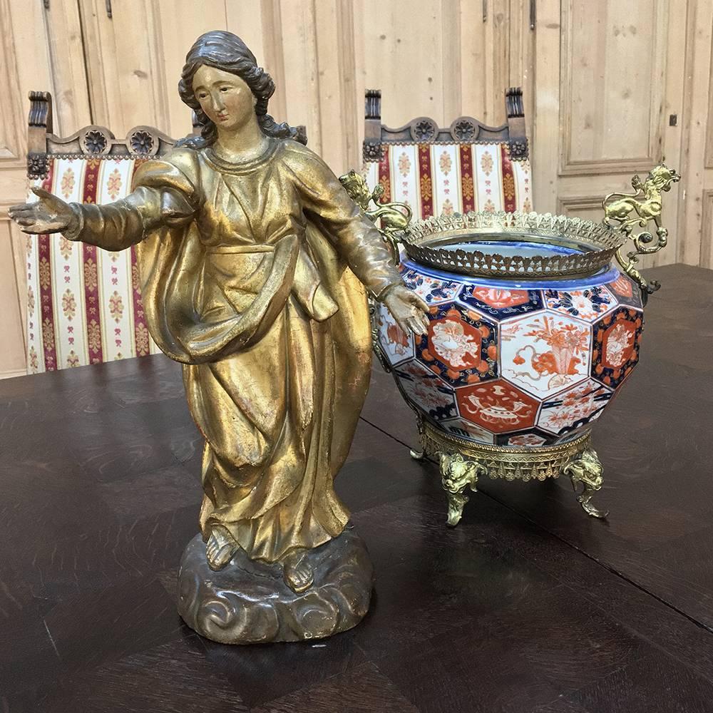 19th century giltwood polychrome statue of Madonna is a superbly artistic rendition of the Mother of Jesus, uncharacteristically holding our both hands in a warm inviting gesture welcoming the devoted to the flock. Original polychrome finish retains