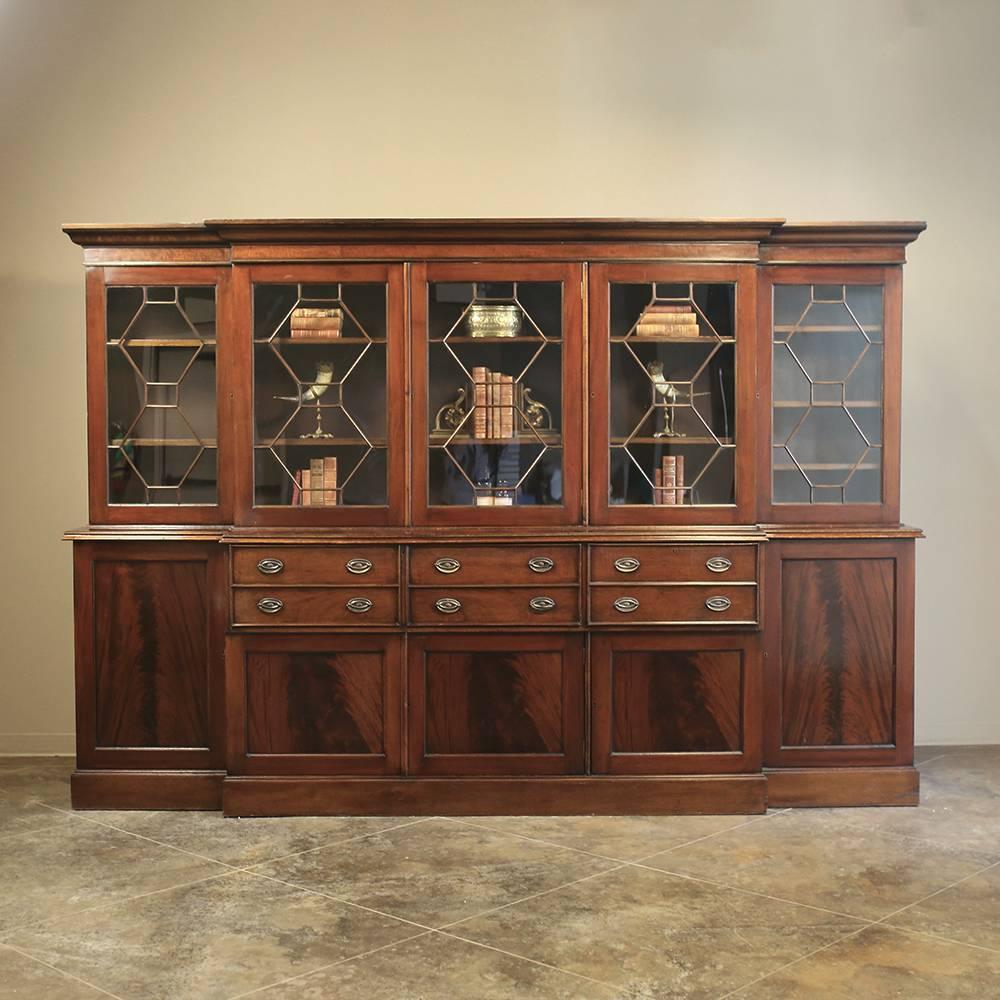 Monumental 19th century grand English mahogany bookcase. Secretary is almost eleven feet wide, and was created for an impressive manoir, and features no less than five glazed cabinets above and six drawers with five cabinets below or so it seems!
