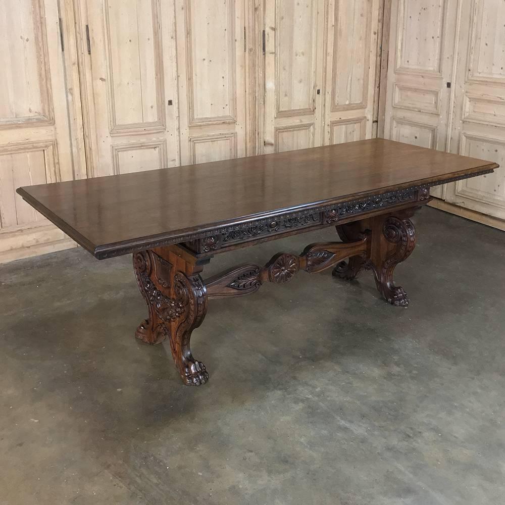Antique Italian Baroque walnut table desk is a splendid testament to the talents of the master Italian sculptors who created full relief images of della Robbia (bounty of the earth), rosettes, foliates and lions' paw feet, all to create a splendid