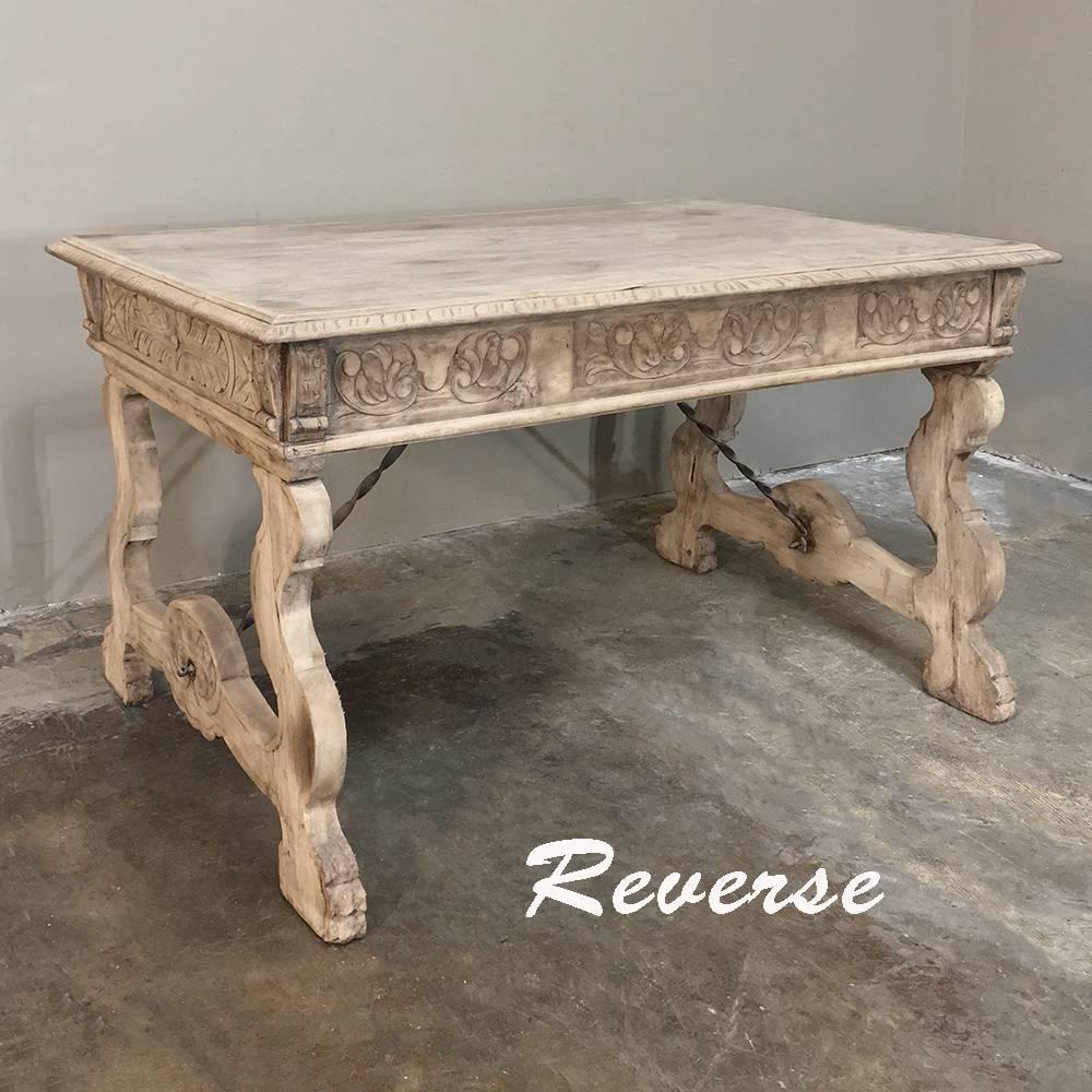 Antique Spanish stripped oak desk with wrought iron stretchers is ideal for a cozy office, as a student desk, or as an ancillary desk to the main executive desk in the room. Three drawers provide utility, while the finely carved apron all round,