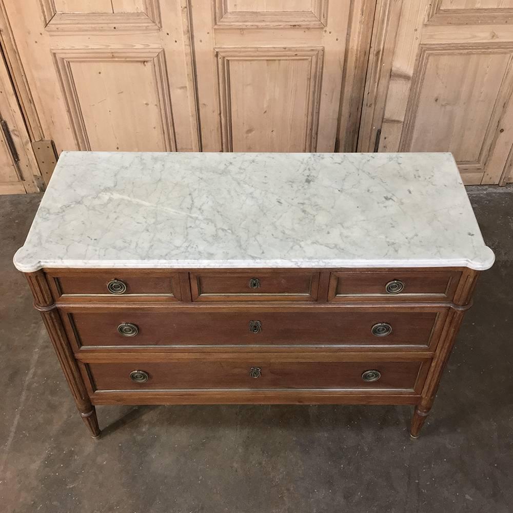 19th century French Directoire mahogany marble-top commode represents the epitome of tailored styling, with framework that is designed to accentuate the sheer natural beauty of the exotic imported mahogany! For a classical touch, the corner posts