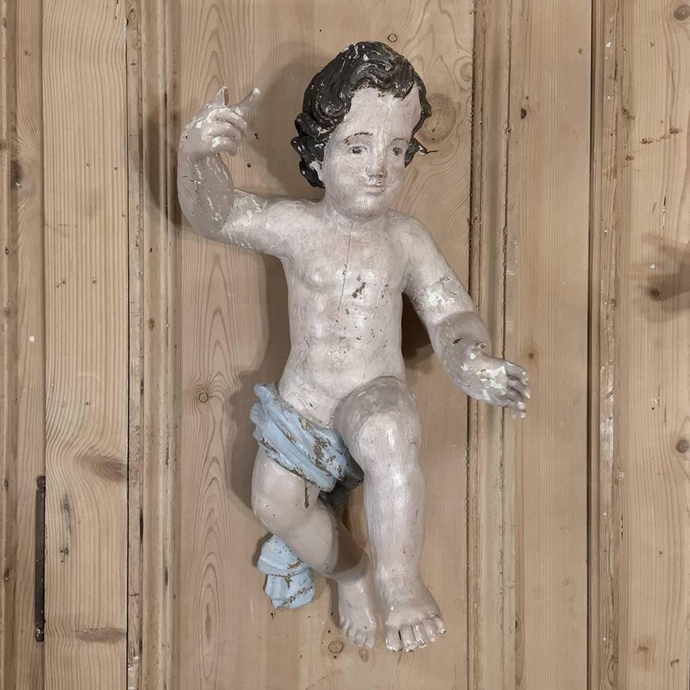 Pair of 18th Century Italian Painted Putti Figures from late Italian Baroque period, feature their original painted finish which has achieved a lovely patina over the centuries, and being of Italian origin, were sculpted from solid wood. Acquired