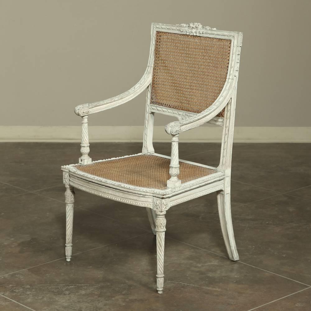 Fitted with caned seat-back and seat for elegant comfort 19th century French Neoclassical Louis XVI painted armchair boasts an original painted finish that has achieved a lovely patina over the last century.
circa 1890s
Measures: 38 H x 23.5 W x