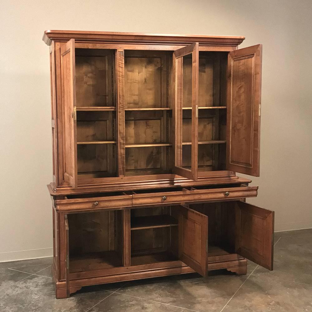 Antique Louis Philippe style cherrywood bookcase which also would make a great dining room piece, was handcrafted in the style which has remained popular for over a century and a half. Here we have an early 20th century rendition that was made from