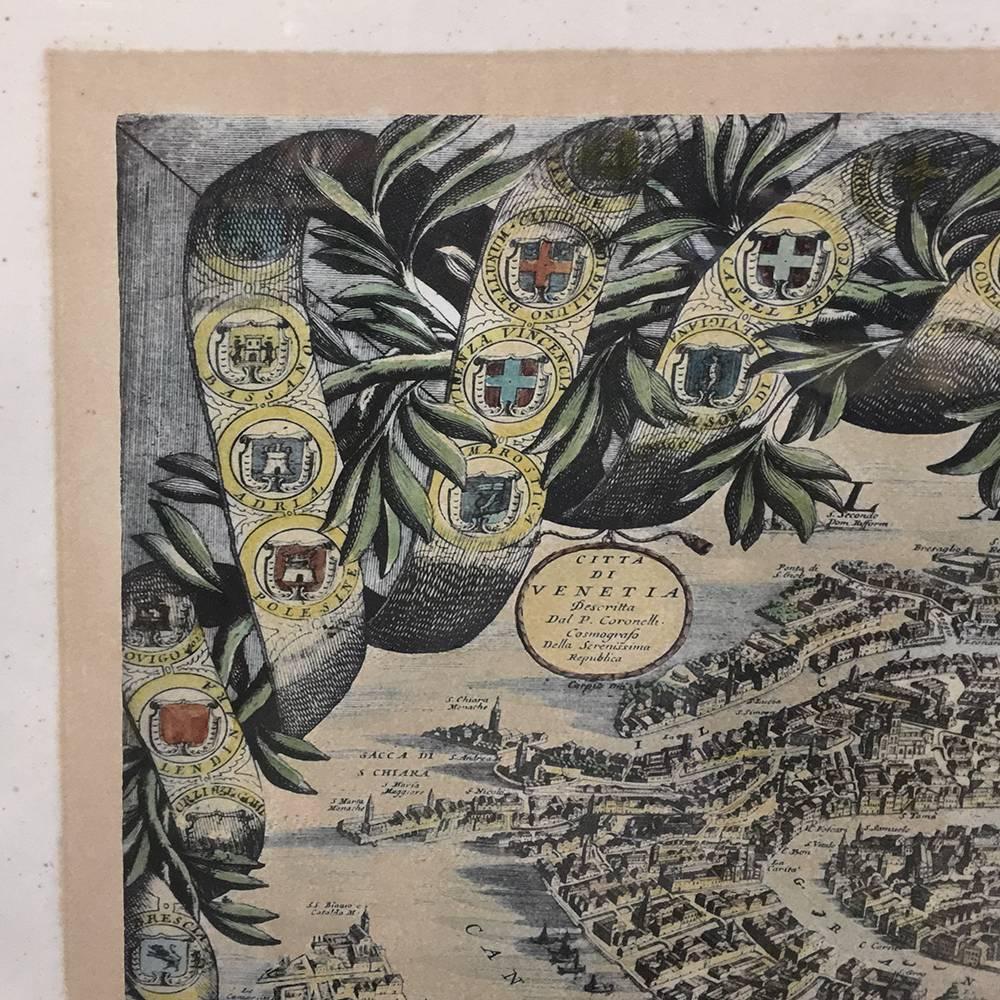 Antique framed lithograph map of Venice is adorned with the family crests of the nobility who called the fabled city home, with a surprisingly detailed and relatively accurate drawing of the layout of the city, a significant amount of which was
