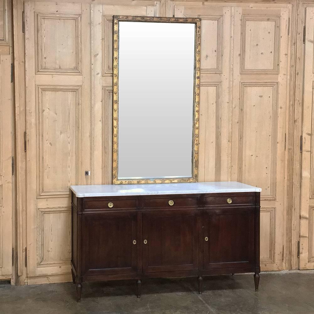Antique Neoclassical Mirror is framed such that if one needed a horizontal mirror over a wide fireplace mantel, for instance, just rotate it 90 degrees! Handcrafted patinaed gold finish on the tailored lines of the frame make this a great choice for