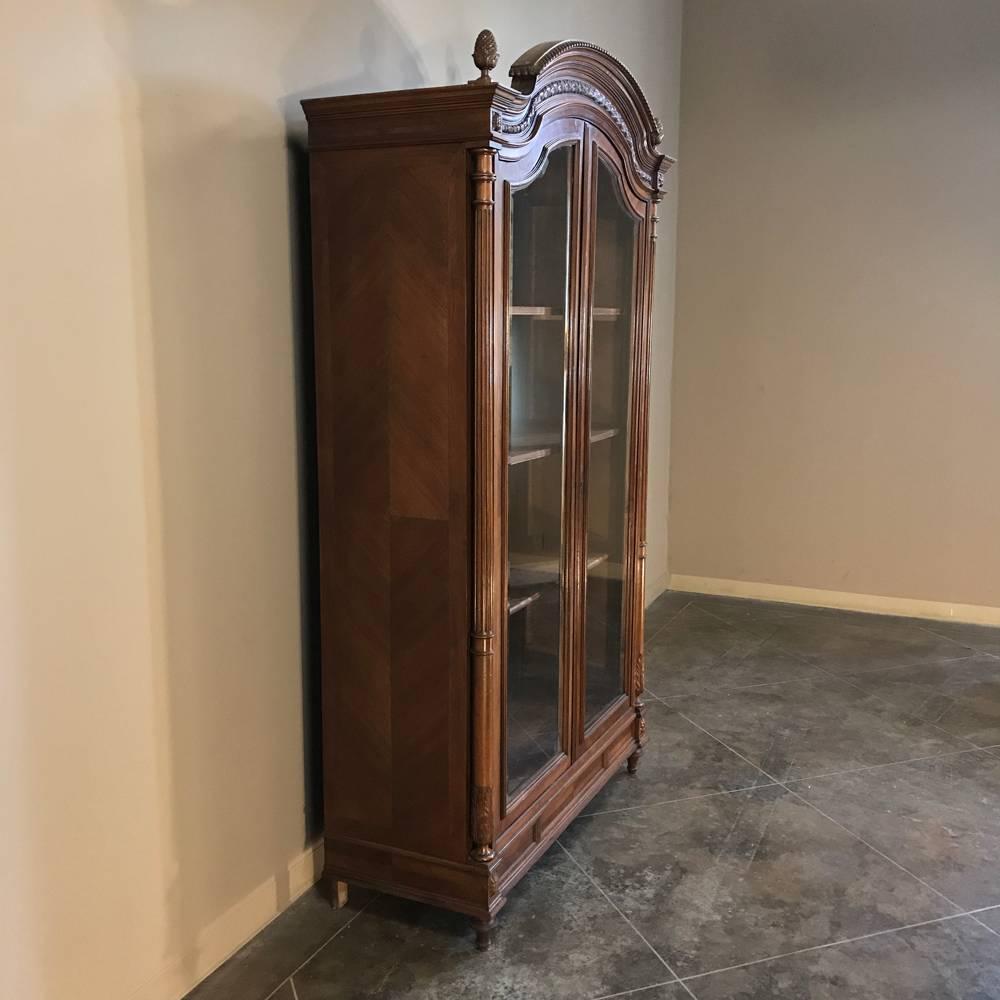 19th century French Louis XVI bookcase, display armoire is a majestic way to display your finest collection and cherished family heirlooms! Also a great choice as a bookcase in a neoclassic setting, it was hand-carved and crafted from solid French