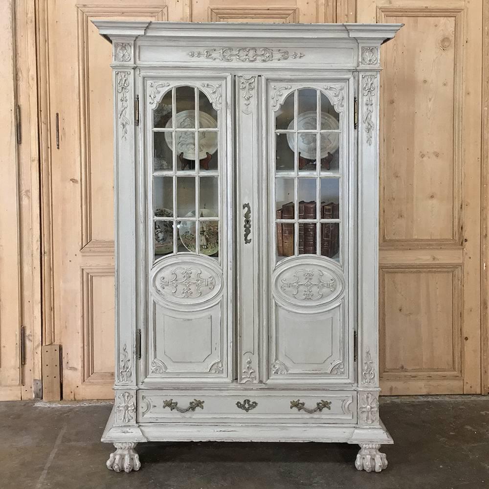 Gorgeous antique furniture details abound in this handsome 19th century Louis XIV French painted bookcase, Bibliotheque, Vitrine, featuring a patinaed, distressed painted finish that is so in vogue today! Classical architecture and embellishment