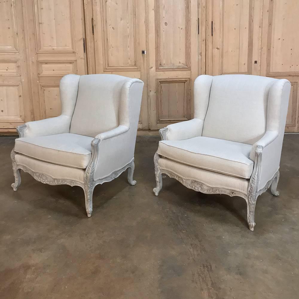 Pair antique 19th Century French Louis XV painted armchairs, bergeres represent the ultimate in comfort and style! Elegant lines with carved detail across the apron and legs with a painted finish that has achieved a lovely patina, with comfort in