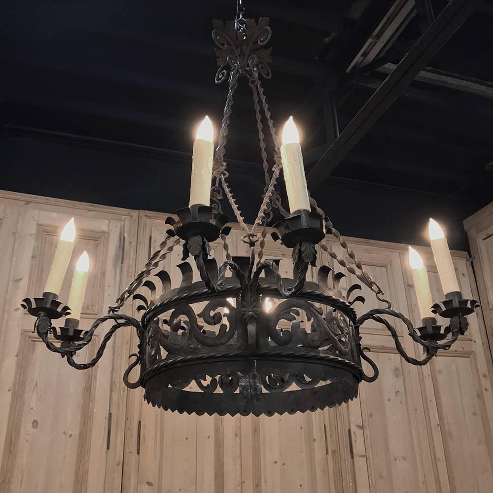 Antique Italian wrought iron chandelier is the perfect choice to create a Tuscan ambiance to complement your decor in any room! Finely hand-forged in a scrolled foliate pattern, it features twisted rod arms holding the floret bobeches, with twisted