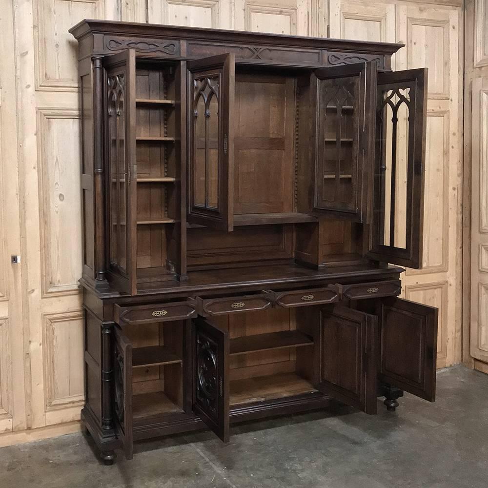 19th century Gothic walnut bookcase is over eight feet tall, yet only 19 inches deep making it the perfect choice for high-traffic areas or cozy offices! Timeless Gothic styling is very subdued, making it more compatible with a wider range of