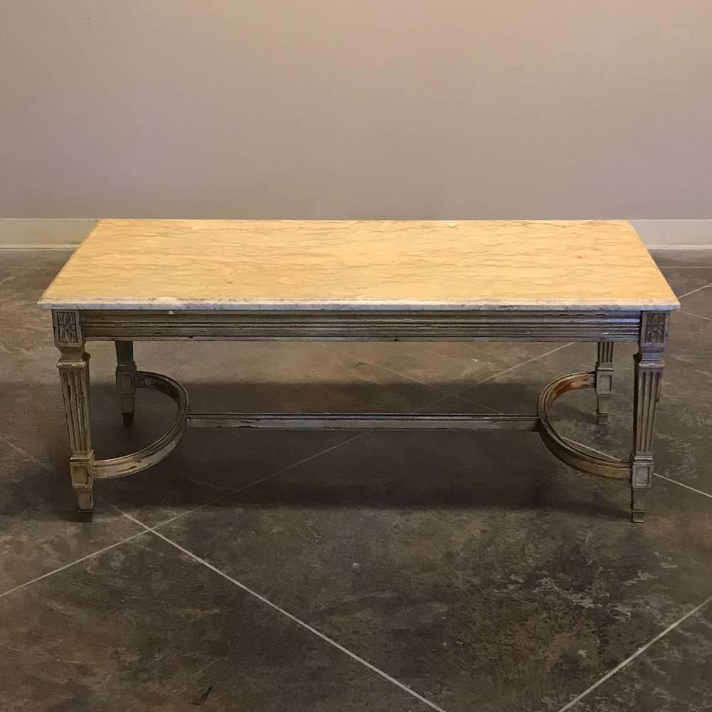Midcentury French gilded Louis XVI marble-top coffee table features neoclassical excellence in design accentuated by the antique gilt finish which has achieved a lovely distressed patina over the decades. What else but fine Sienna marble for the