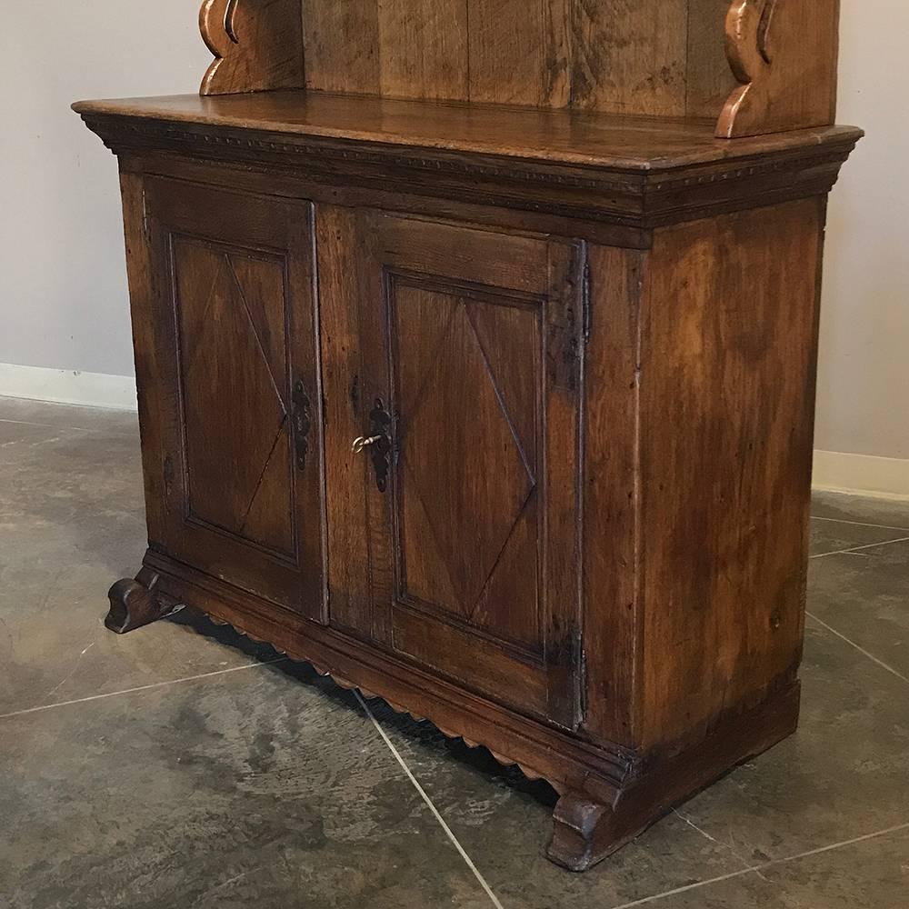 18th century rustic Swedish oak vaisselier is ideal for the casual decor, and provides storage, a serving surface, and display racks, all in one! Handcrafted from solid oak to endure for generations, it features a modicum of embellishment in the