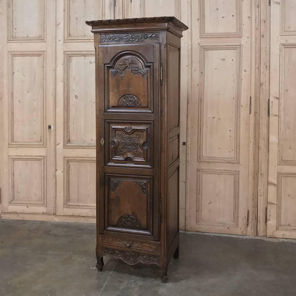 18th Century French Regence Period Bonnetiere is a remarkable example of rural French artisanry from the storied Bordeaux region, with a solid casework joined with pegged mortise & tenon techniques, and hand-carved molding and detail adornment that