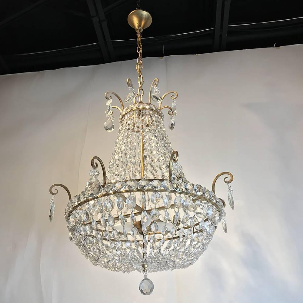 Mid-Century Crystal Chandelier is the perfect choice for livening up any room, with brass frame and multiple designs of crystals to play with the light. Sold as is, electrification is extra. Contact us for electrification options and costs,
circa