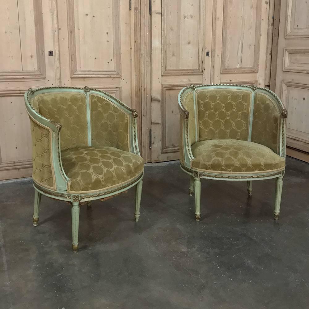 Pair of antique Italian Louis XVI painted bergeres feature timeless classical architecture inspired by ancient Greece and Rome! Curved and fully upholstered armrests connect to the seatback for wraparound comfort. Tapered and fluted legs provide