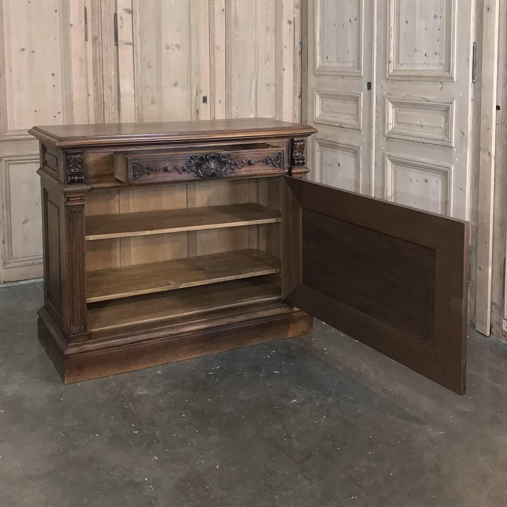 19th century French walnut Louis XIV low buffet or cabinet is a remarkable creation, and definitely one of the widest single door buffets we've seen, certainly one of the most elegant, having been hand-sculpted from select French walnut in the