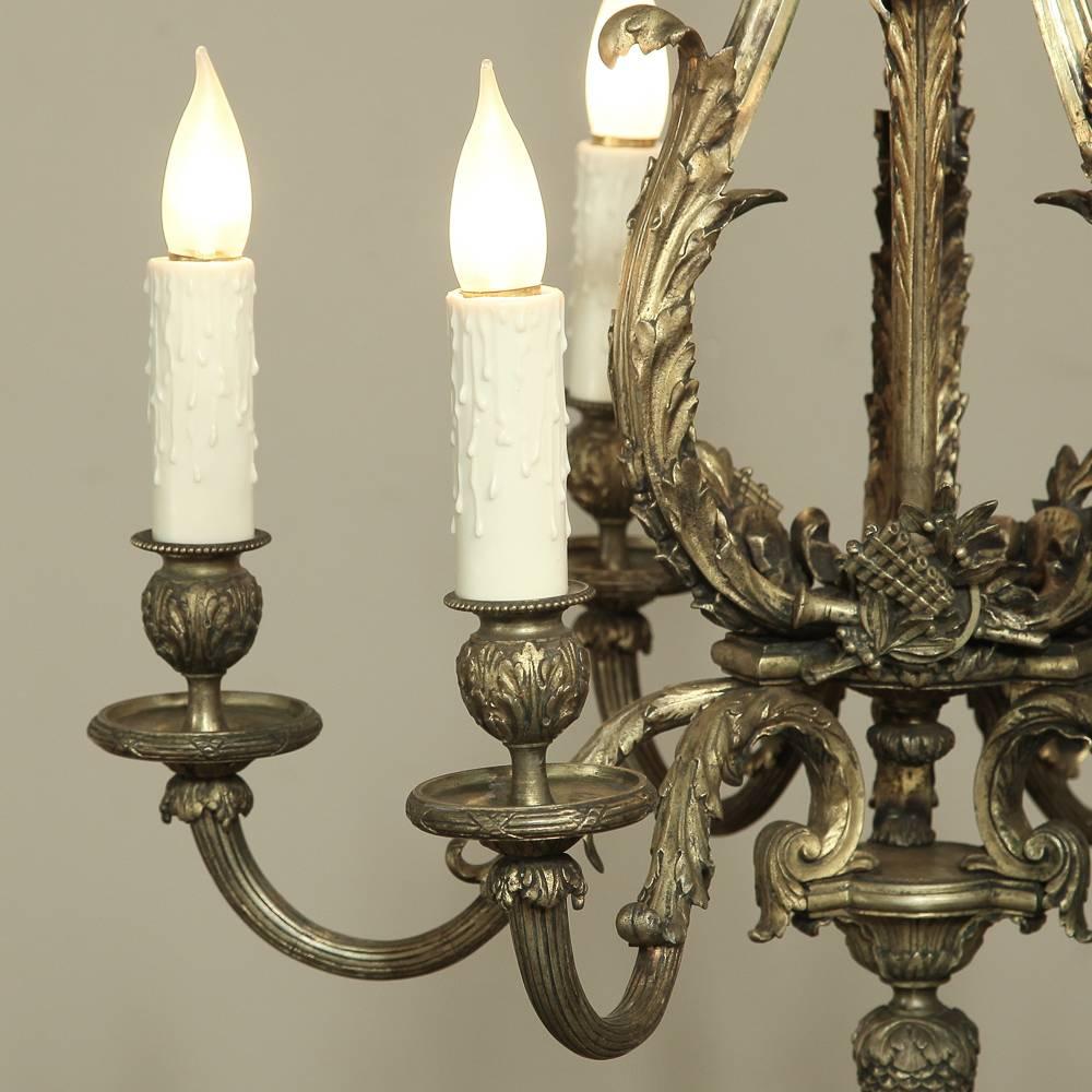This exquisite Louis XV chandelier was cast in solid bronze and brass and displays both Baroque and Neoclassical elements-making it an ideal choice for most any interior! Today, it has been totally rewired cleaned and ready to hang in your