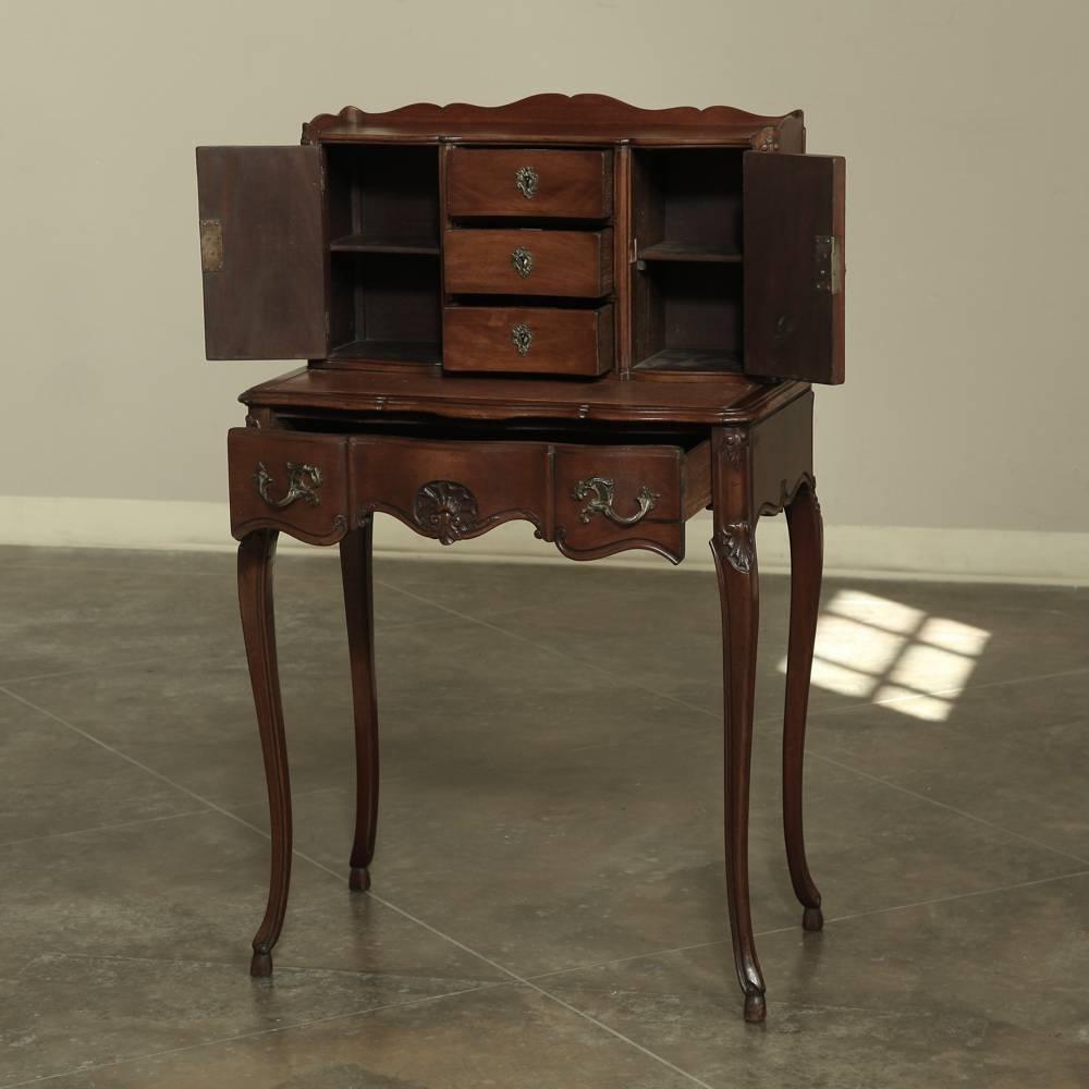 Antique French Walnut Rococo vanity ~ desk features an original leather writing surface!  Elegant drawers and cabinets above charming bronze hardware drawers under the surface provide ample storage, with naturalistic scrollwork, hand-carved detail