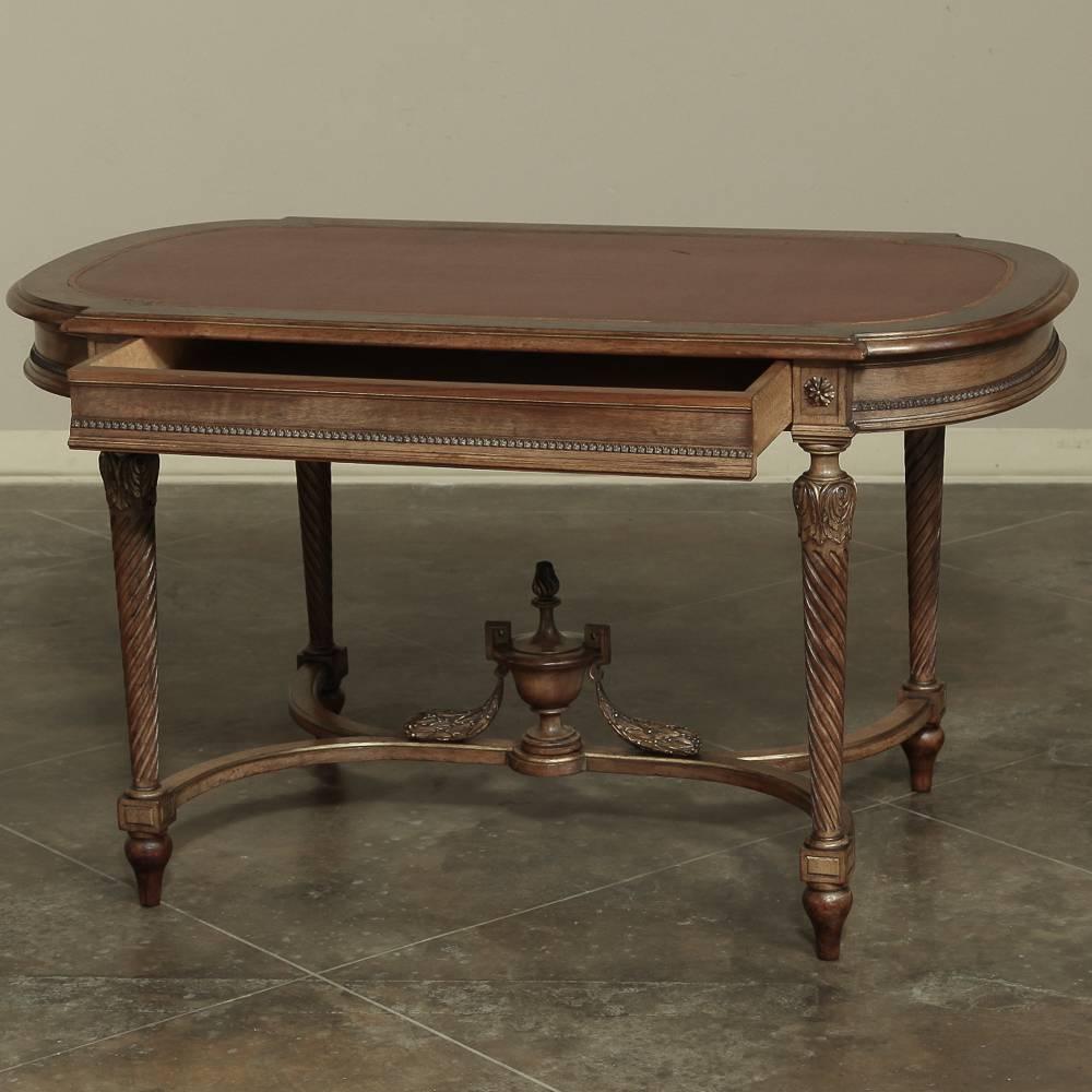 19th century French hand carved Louis XVI Walnut neoclassical writing desk with gilded highlights and timeless architectural styling is a most functional piece of antique furniture, featuring a single drawer for convenience and perfect desk surface