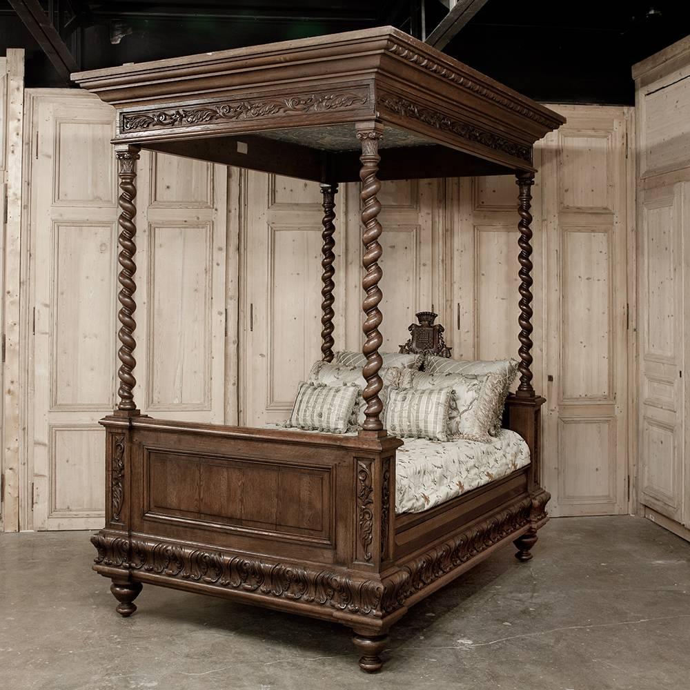 This stunning Renaissance Revival bedroom suite has remained together for well over a century and a half! Consisting of a captivating canopy bed with four barley twist columns, an armoire with a regal crest and full length mirror flanked by barley
