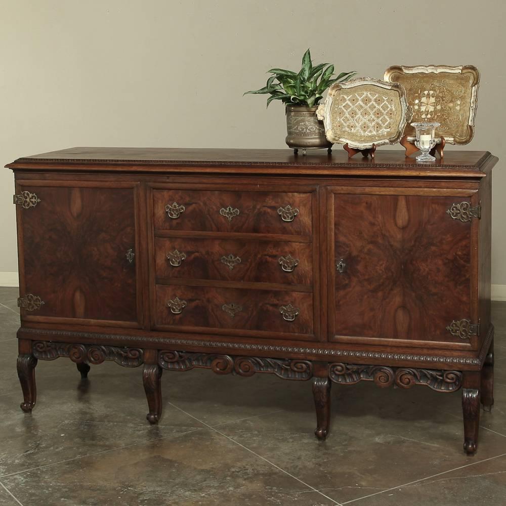 Antique Chippendale Sideboard  with burl walnut veneers is raised on scrolled legs with an intricately hand-carved apron.
Circa early 1900s.
Measures: 44 H x 79 W x 23 D.