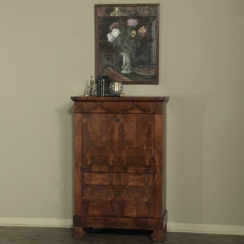 Hand-crafted from exotic imported mahogany during the mid-19th Century, this French Louis Philippe Secretary was the workstation of its day! Requiring only a small footprint on a floorspace, it housed drawer space, a display and decorating surface,