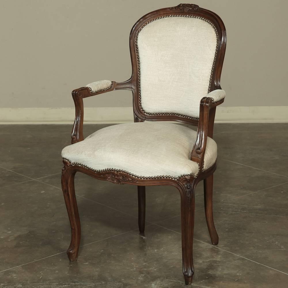 Hand-crafted from select French Walnut, this exquisite set of Eight DIning Chairs were sculpted in the manner of Louis XV with Rococo-inspired carvings and fluid lines that will add grace and beauty to your dining room! Upholstered in exquisite