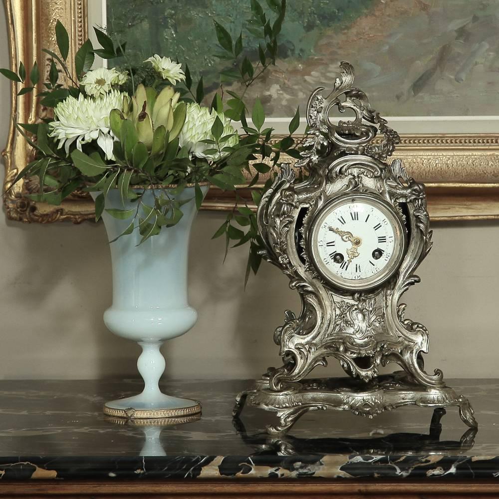 19th century French Rococo bronze mantel clock with nickel washed finish makes the excellent choice to accessorize any room, bringing the sensuous naturalistic form of the style favored by Louis XV in the form of an exquisite timekeeping device.