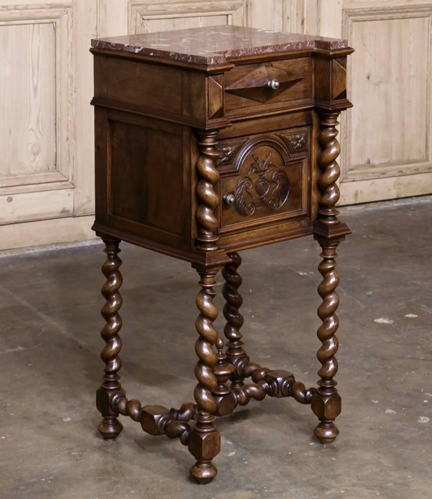 Handcrafted from solid French Walnut, this amazing 19th century barley twist marble-top nightstand is the ideal choice for the old world look! Original rouge marble coupled with hand-carved rosettes and foliate designed provide a handsome effect,