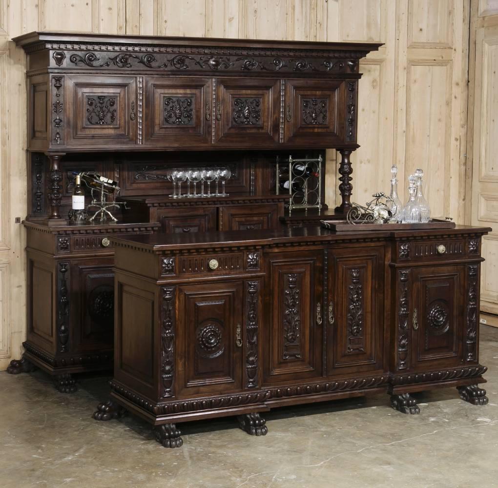 Sculpted from fine Italian walnut, this splendid Antique Italian Renaissance Buffet features two tiers, the upper of which is supported by finely carved and turned columns, and fitted with beautifully carved chamfered panels ~ and the lower of which