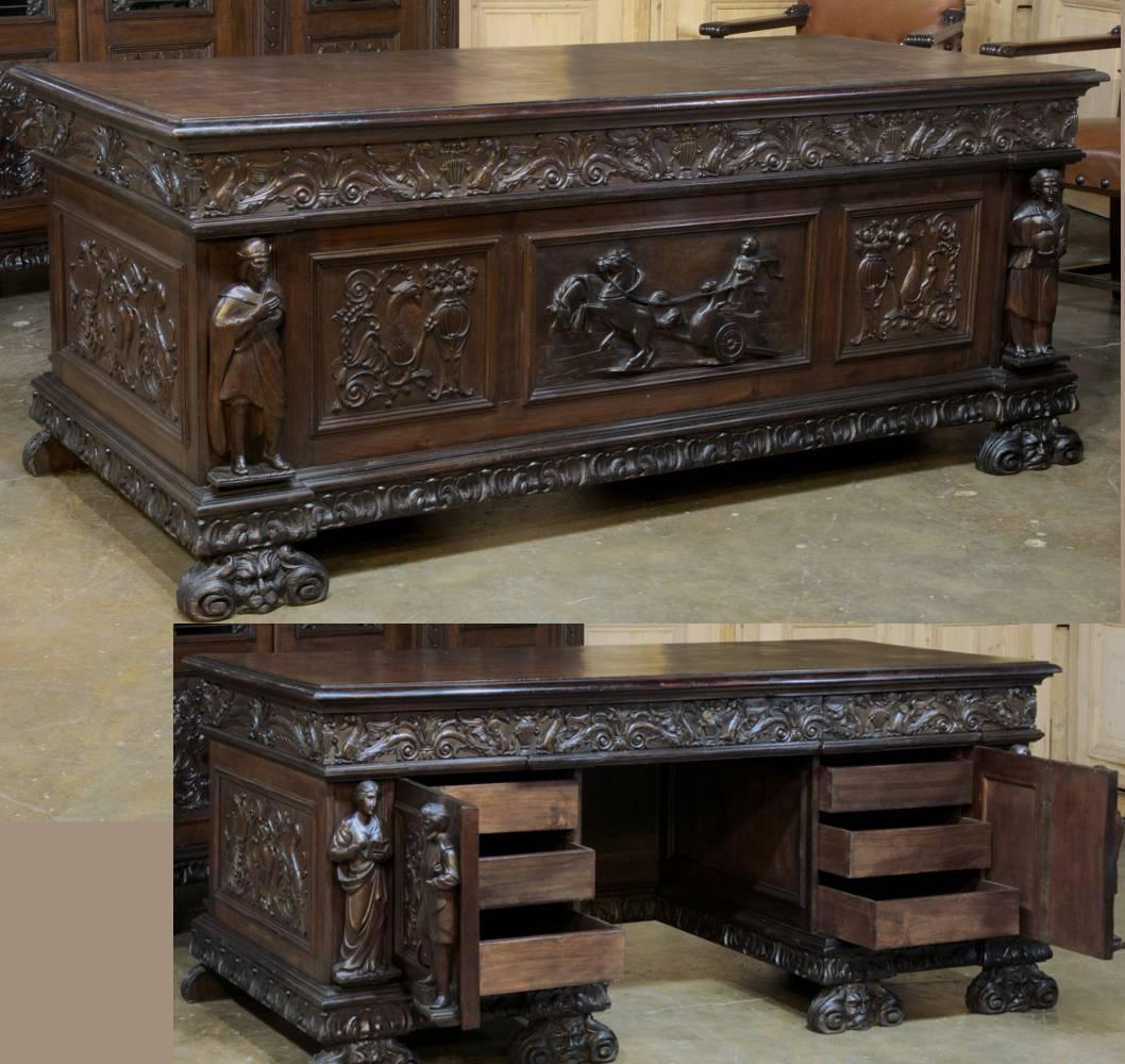 Exquisitely sculpted from solid Italian walnut by master artisans, this exceptional Antique Grand Italian walnut Renaissance executive's office suite consists of a grand desk that features statuary on each corner representing literature, music,